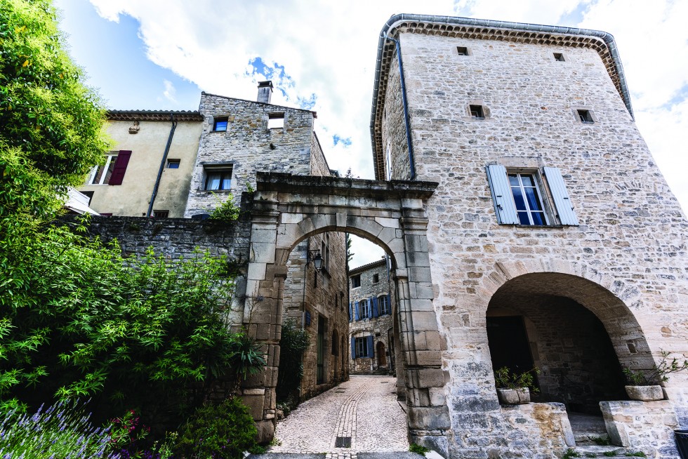 Many cafes shelter from the sun under city fortifications.